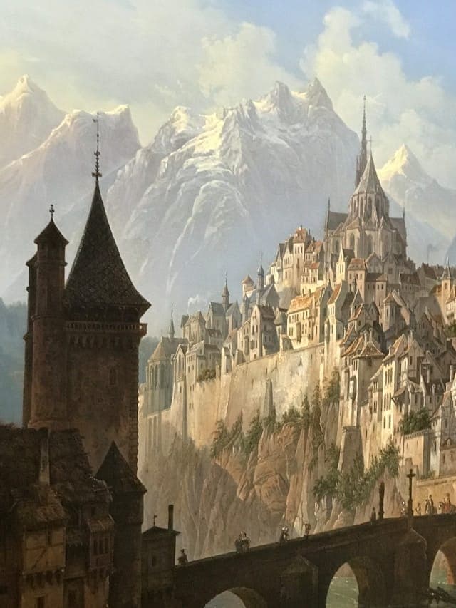 Fantasy cityscape with medieval architecture, towering spires, and a castle on a cliff, set against snow-capped mountains and a stone bridge.